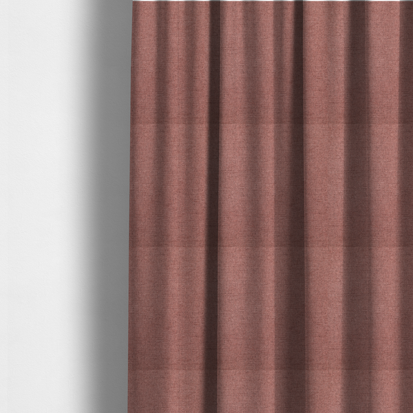 The fabric used to create these made-to-measure curtains is a finely textured weave in a soft, dusty rose or blush pink shade. The material has a subtle heathered appearance with fine variations of lighter pink and darker undertones throughout.