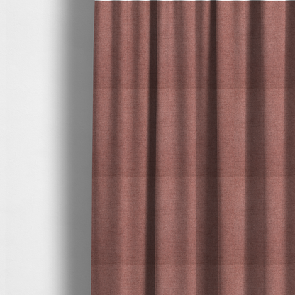 The fabric used to create these made-to-measure curtains is a finely textured weave in a soft, dusty rose or blush pink shade. The material has a subtle heathered appearance with fine variations of lighter pink and darker undertones throughout.