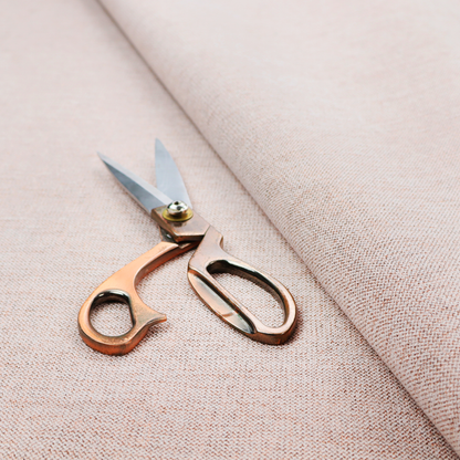 A finely textured weave in a soft blush-beige or oatmeal shade. The material features a subtle heathered effect mixed with fine beige, cream, and faint grey undertones throughout.