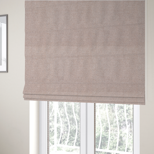 The fabric used to create these Roman blinds is a finely textured weave in a soft blush-beige or oatmeal shade. The material features a subtle heathered effect mixed with fine beige, cream, and faint grey undertones throughout.