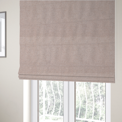 The fabric used to create these Roman blinds is a finely textured weave in a soft blush-beige or oatmeal shade. The material features a subtle heathered effect mixed with fine beige, cream, and faint grey undertones throughout.