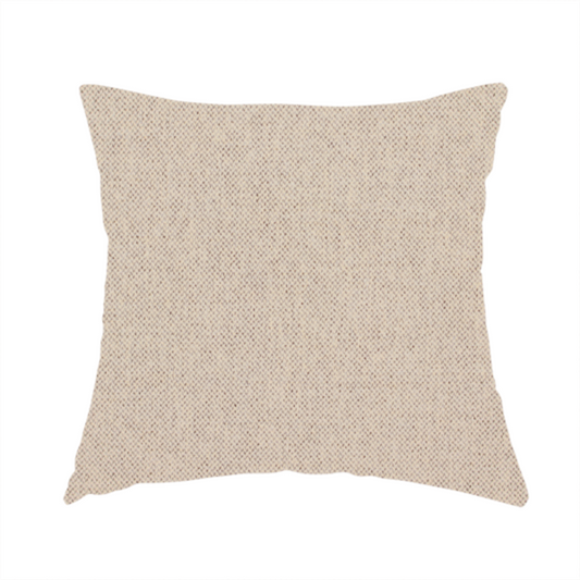 The fabric used to create this handmade cushion is a finely textured weave in a soft cream or light ivory shade. The material features a subtle heathered look with tiny flecks of beige and neutral undertones throughout.