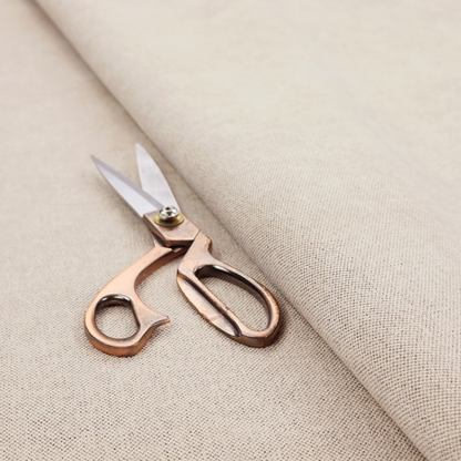 A finely textured weave in a soft cream or light ivory shade. The material features a subtle heathered look with tiny flecks of beige and neutral undertones throughout.