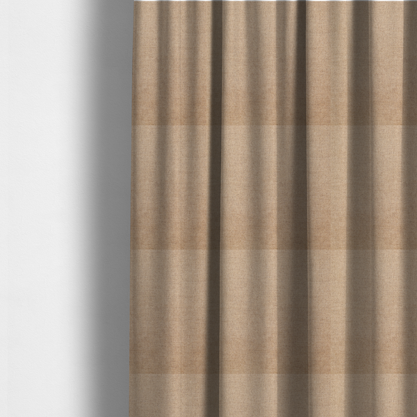 The fabric used to create these made-to-measure curtains is a finely textured weave in a sandy tan or camel shade. The material features a subtle heathered look with mixed light brown, cream, and neutral undertones throughout.