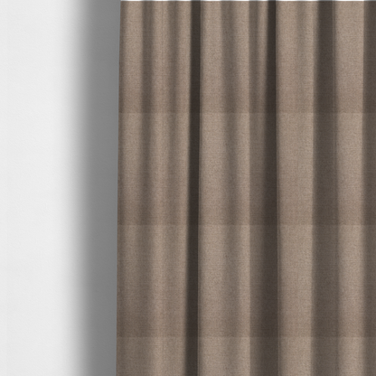The fabric used to create these made-to-measure curtains is a finely textured weave in a warm taupe or light brownish-grey shade. The material features a subtle heathered look with finely blended threads of tan, cream, and soft brown undertones throughout.