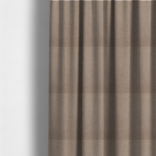 The fabric used to create these made-to-measure curtains is a finely textured weave in a warm taupe or light brownish-grey shade. The material features a subtle heathered look with finely blended threads of tan, cream, and soft brown undertones throughout.