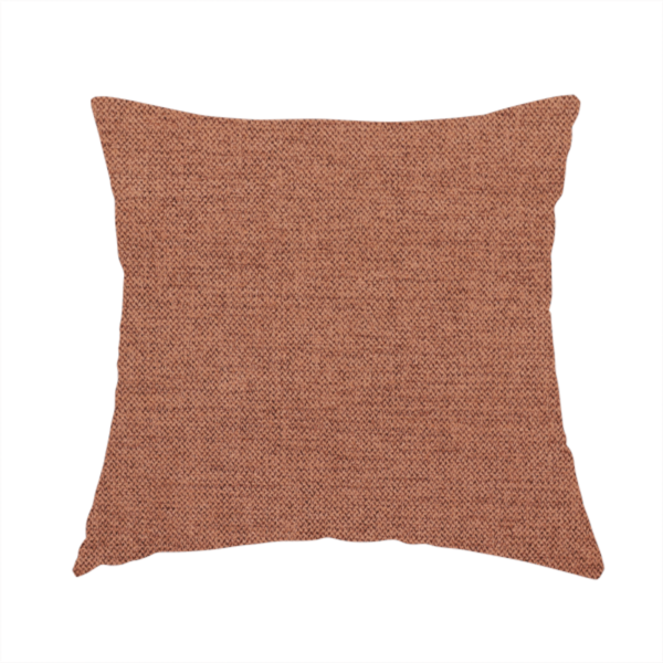 The fabric used to create this handmade cushion is a finely textured weave in a soft terracotta, rust, or muted copper shade. The material features a subtle heathered look with finely blended threads of warm orange-brown and darker neutral undertones throughout.