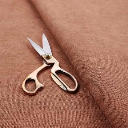 A finely textured weave in a soft terracotta, rust, or muted copper shade. The material features a subtle heathered look with finely blended threads of warm orange-brown and darker neutral undertones throughout.