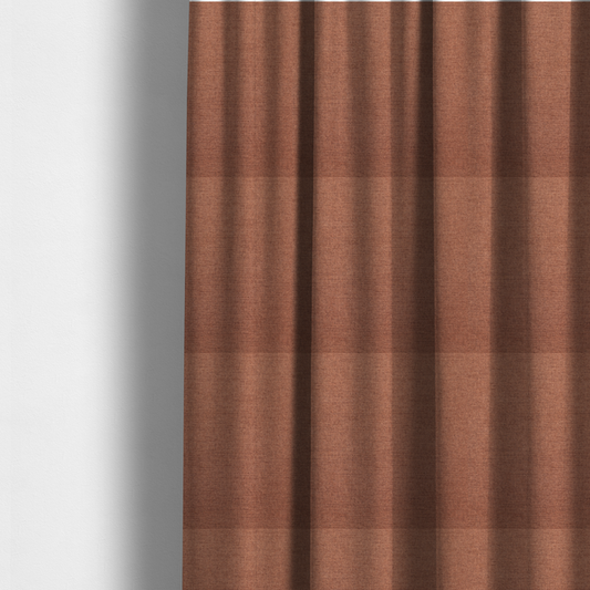 The fabric used to create these made-to-measure curtains is a finely textured weave in a soft terracotta, rust, or muted copper shade. The material features a subtle heathered look with finely blended threads of warm orange-brown and darker neutral undertones throughout.