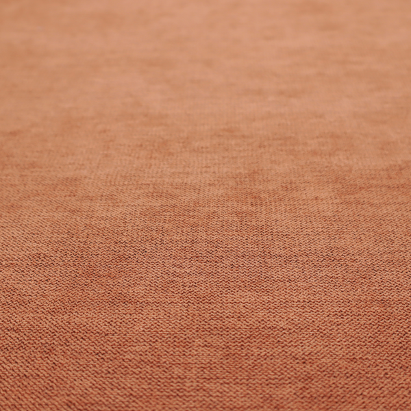 A finely textured weave in a bright ginger, amber, or light rust shade. The material features a subtle heathered look with finely blended threads of warm orange and darker neutral undertones throughout.