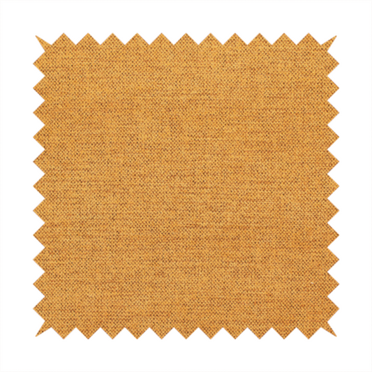 A finely textured weave in a rich mustard yellow or golden-amber shade. The material features a subtle heathered look with finely blended threads of warm yellow and darker neutral undertones throughout.