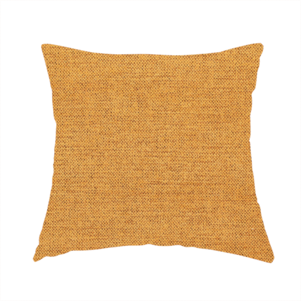 The fabric used to create this handmade cushion is a finely textured weave in a rich mustard yellow or golden-amber shade. The material features a subtle heathered look with finely blended threads of warm yellow and darker neutral undertones throughout.