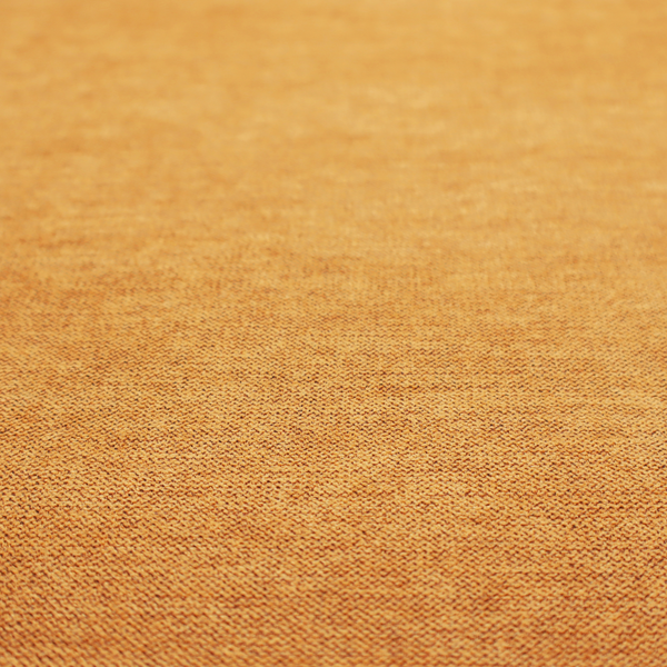 A finely textured weave in a rich mustard yellow or golden-amber shade. The material features a subtle heathered look with finely blended threads of warm yellow and darker neutral undertones throughout.