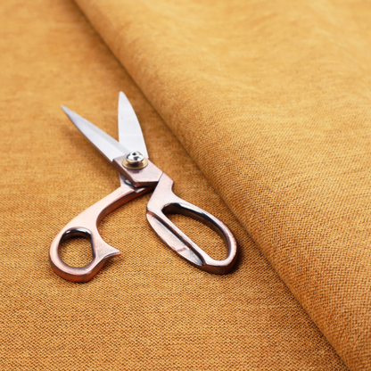 A finely textured weave in a rich mustard yellow or golden-amber shade. The material features a subtle heathered look with finely blended threads of warm yellow and darker neutral undertones throughout.