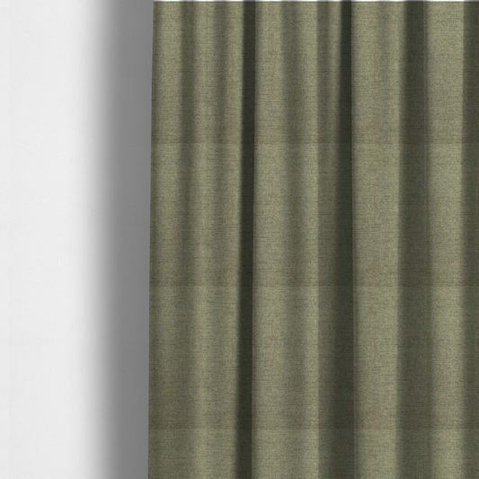 The fabric used to create these made-to-measure curtains is a finely textured weave in a muted sage, olive, or light moss green shade. The material features a subtle heathered look with finely blended threads of earthy green and darker neutral undertones throughout.