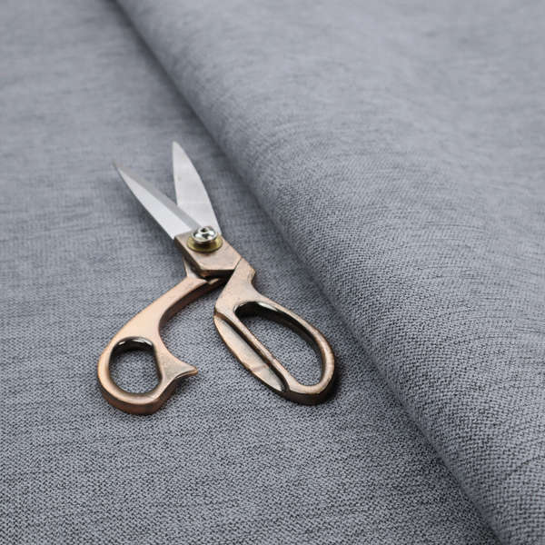 A finely textured weave in a medium steel grey or slate grey shade. The material features a subtle heathered look with finely blended threads of cool grey, soft charcoal, and muted blue-grey tones throughout.
