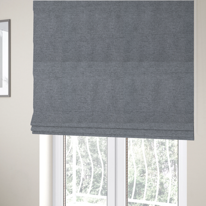 The fabric used to create these Roman blinds is a  finely textured weave in a medium steel grey or slate grey shade. The material features a subtle heathered look with finely blended threads of cool grey, soft charcoal, and muted blue-grey tones throughout.