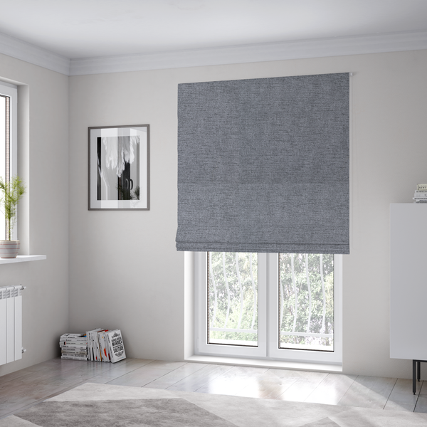 The fabric used to create these Roman blinds is a  finely textured weave in a medium steel grey or slate grey shade. The material features a subtle heathered look with finely blended threads of cool grey, soft charcoal, and muted blue-grey tones throughout.