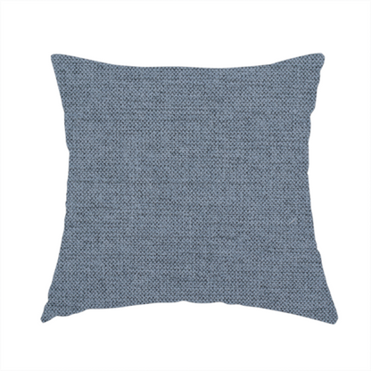 The fabric used to create this handmade cushion is a finely textured weave in a soft denim, slate blue, or pigeon blue shade. The material features a subtle heathered look with finely blended threads of muted blue and cool grey undertones throughout.