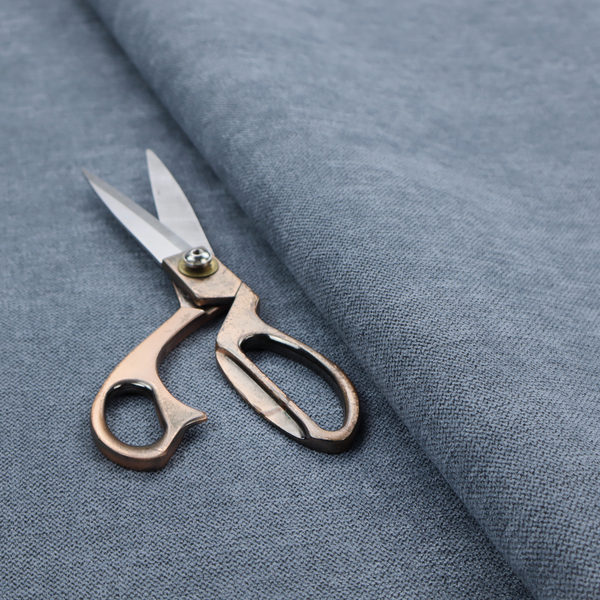 A finely textured weave in a soft denim, slate blue, or pigeon blue shade. The material features a subtle heathered look with finely blended threads of muted blue and cool grey undertones throughout.