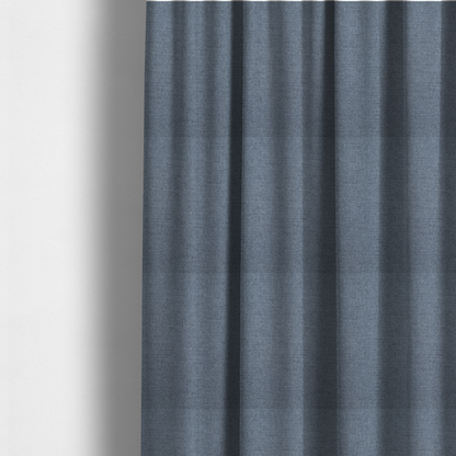 The fabric used to create these made-to-measure curtains is a finely textured weave in a soft denim, slate blue, or pigeon blue shade. The material features a subtle heathered look with finely blended threads of muted blue and cool grey undertones throughout.