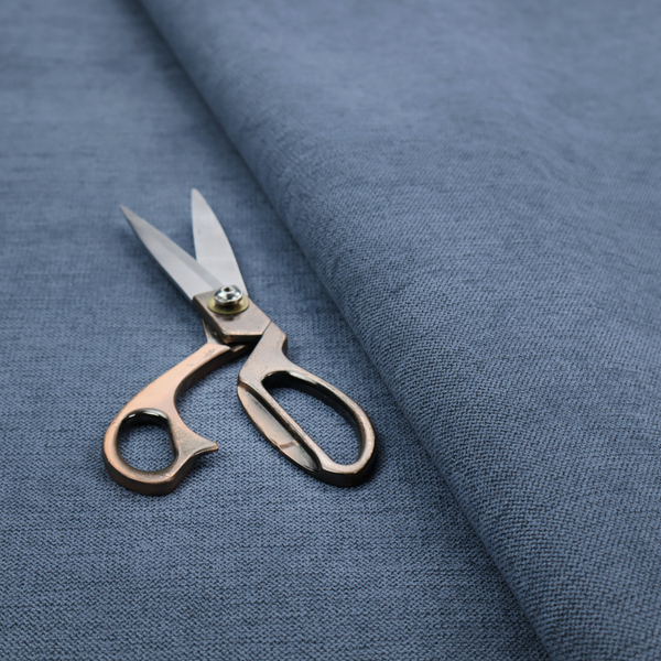 A finely textured weave in a rich mid-blue, ocean blue, or deep slate blue shade. The material features a subtle heathered look with finely blended threads of classic blue and darker grey undertones throughout.