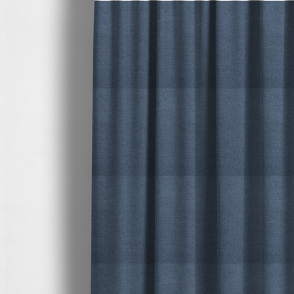 The fabric used to create these made-to-measure curtains is a finely textured weave in a rich mid-blue, ocean blue, or deep slate blue shade. The material features a subtle heathered look with finely blended threads of classic blue and darker grey undertones throughout.