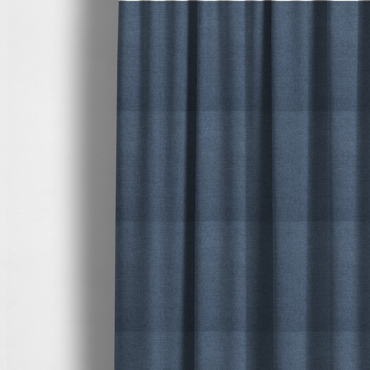 The fabric used to create these made-to-measure curtains is a finely textured weave in a rich mid-blue, ocean blue, or deep slate blue shade. The material features a subtle heathered look with finely blended threads of classic blue and darker grey undertones throughout.