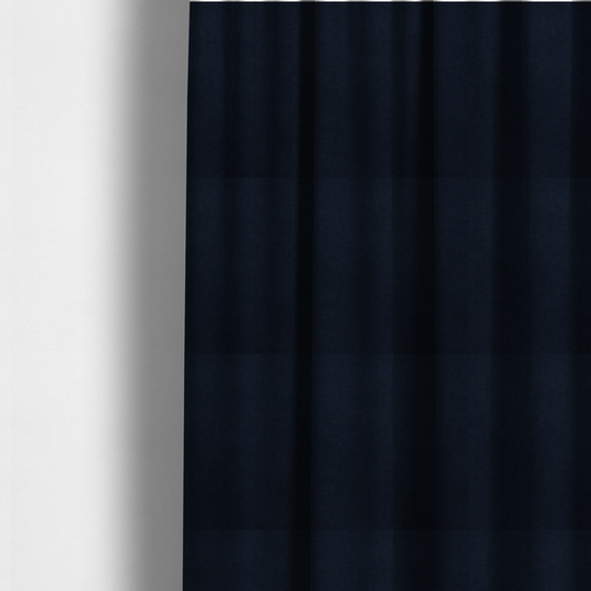 The fabric used to create these made-to-measure curtains is a finely textured, tight weave in a deep navy or midnight blue shade. The material features a subtle, uniform micro-textured look with very dark neutral undertones throughout.