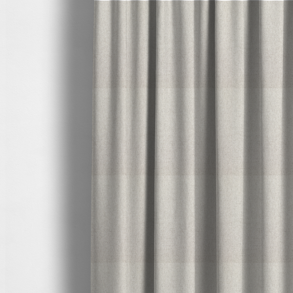 The fabric used to create these made-to-measure curtains is a finely textured weave in a pale cream, ivory, or oatmeal shade. The material features a subtle heathered look with finely blended threads of soft white and light neutral beige undertones throughout.