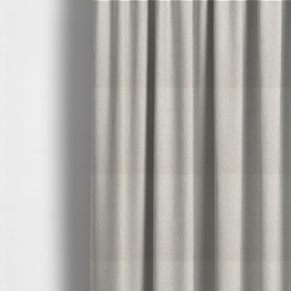 The fabric used to create these made-to-measure curtains is a finely textured weave in a pale cream, ivory, or oatmeal shade. The material features a subtle heathered look with finely blended threads of soft white and light neutral beige undertones throughout.