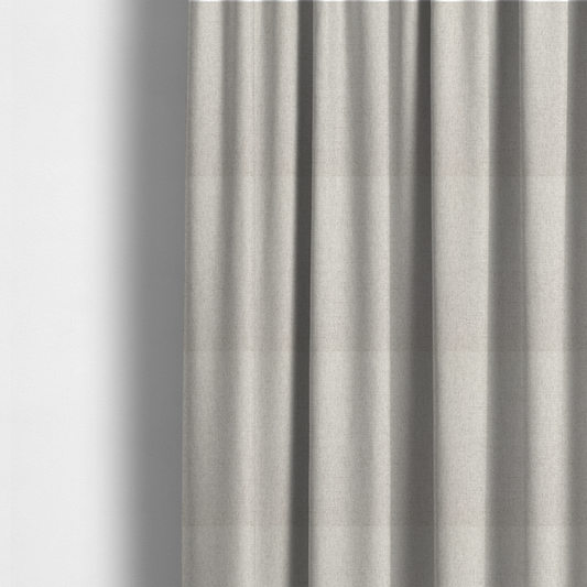 The fabric used to create these made-to-measure curtains is a finely textured weave in a pale cream, ivory, or oatmeal shade. The material features a subtle heathered look with finely blended threads of soft white and light neutral beige undertones throughout.