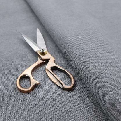 A finely textured weave in a medium mineral grey or cool slate shade. The material features a subtle heathered look with finely blended threads of classic grey, white, and faint charcoal undertones throughout.