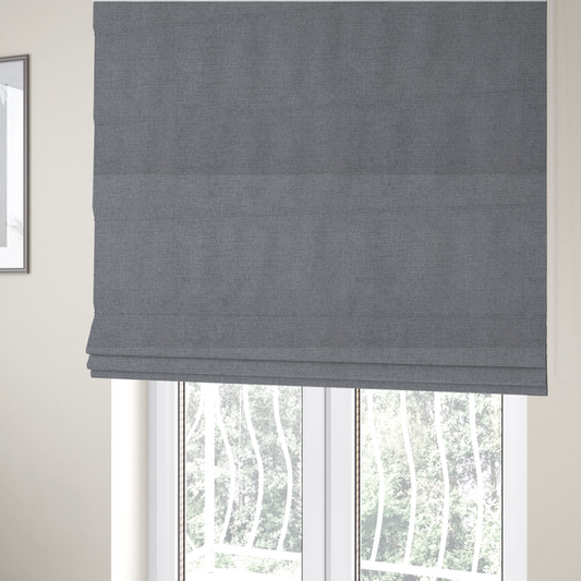 The fabric used to create these Roman blinds is a finely textured weave in a medium mineral grey or cool slate shade. The material features a subtle heathered look with finely blended threads of classic grey, white, and faint charcoal undertones throughout.