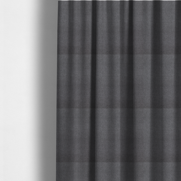 The fabric used to create these made-to-measure curtains is a finely textured weave in a deep charcoal, graphite, or dark slate grey shade. The material features a subtle heathered look with finely blended threads of black, deep grey, and soft ash undertones throughout.