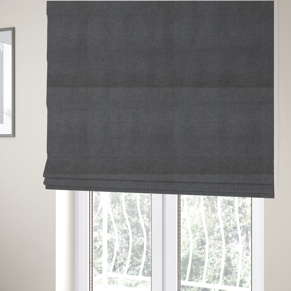 The fabric used to create these Roman blinds is a finely textured weave in a deep charcoal, graphite, or dark slate grey shade. The material features a subtle heathered look with finely blended threads of black, deep grey, and soft ash undertones throughout.