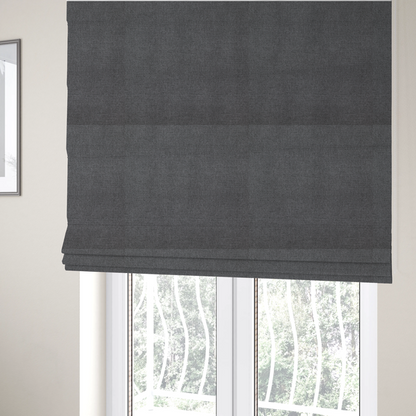 The fabric used to create these Roman blinds is a finely textured weave in a deep charcoal, graphite, or dark slate grey shade. The material features a subtle heathered look with finely blended threads of black, deep grey, and soft ash undertones throughout.