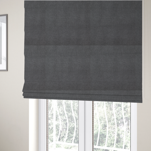 The fabric used to create these Roman blinds is a finely textured weave in a deep charcoal, graphite, or dark slate grey shade. The material features a subtle heathered look with finely blended threads of black, deep grey, and soft ash undertones throughout.