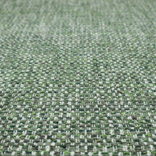 The material features a dense, multi-toned green tweed pattern, intricately interlaced with small flecks of white, bright lime green, and dark brown threads throughout.