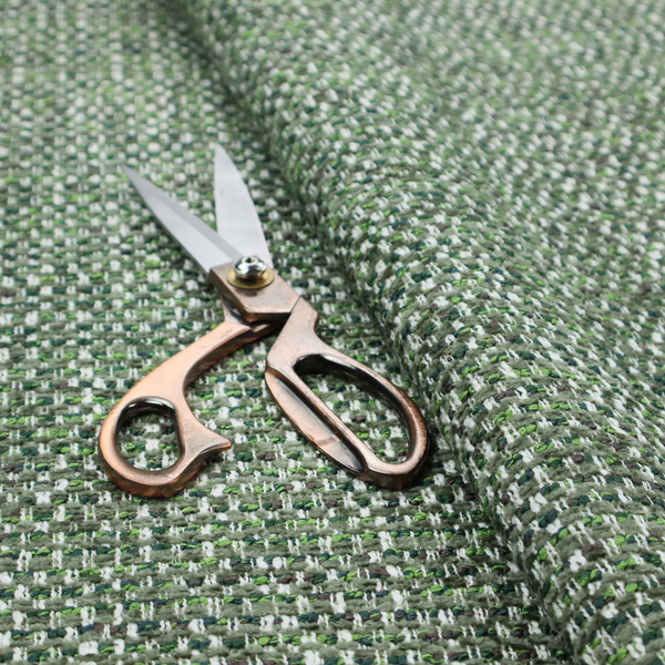 The material features a dense, multi-toned green tweed pattern, intricately interlaced with small flecks of white, bright lime green, and dark brown threads throughout.