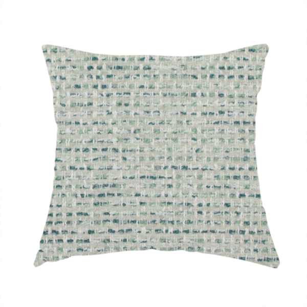 The fabric used to create this handmade cushion is a material features a dense, multi-toned weave with a light cream or off-white background, intricately interlaced with horizontal flecks of teal, mint green, and soft grey threads throughout.