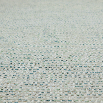 The material features a dense, multi-toned weave with a light cream or off-white background, intricately interlaced with horizontal flecks of teal, mint green, and soft grey threads throughout.