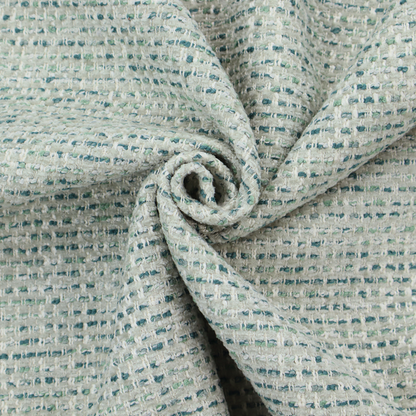 The material features a dense, multi-toned weave with a light cream or off-white background, intricately interlaced with horizontal flecks of teal, mint green, and soft grey threads throughout.