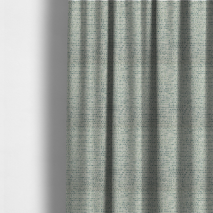 The fabric used to create these made-to-measure curtains is a  material features a dense, multi-toned weave with a light cream or off-white background, intricately interlaced with horizontal flecks of teal, mint green, and soft grey threads throughout.