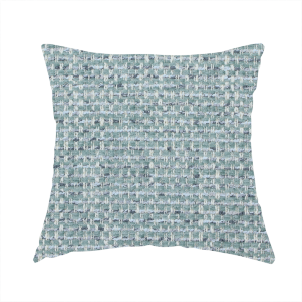 The fabric used to create these handmade cushions is a material features a dense, multi-toned weave with a soft duck egg blue and sage green base, intricately interlaced with horizontal flecks of cream and muted slate grey threads throughout.