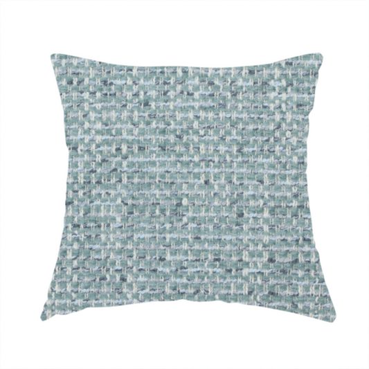 The fabric used to create these handmade cushions is a material features a dense, multi-toned weave with a soft duck egg blue and sage green base, intricately interlaced with horizontal flecks of cream and muted slate grey threads throughout.