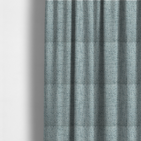 The fabric used to create these made-to-measure curtains is a material features a dense, multi-toned weave with a soft duck egg blue and sage green base, intricately interlaced with horizontal flecks of cream and muted slate grey threads throughout.