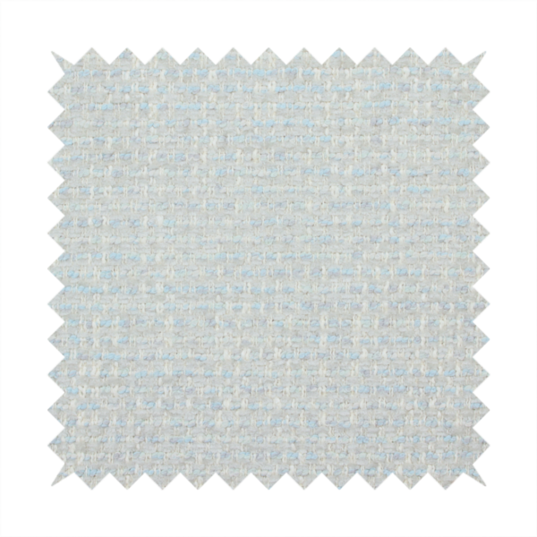 The material features a dense, light-toned weave with a pale cream and off-white base, subtly interlaced with delicate horizontal flecks of soft baby blue and light grey threads throughout.