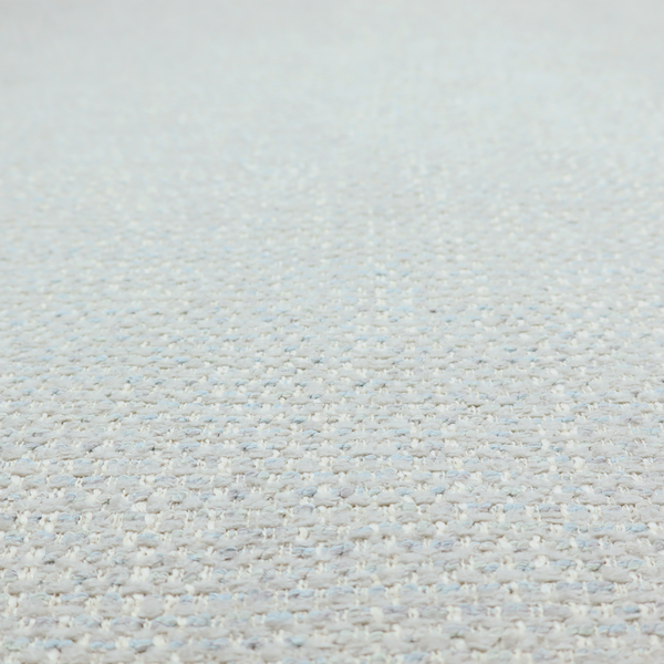 The material features a dense, light-toned weave with a pale cream and off-white base, subtly interlaced with delicate horizontal flecks of soft baby blue and light grey threads throughout.