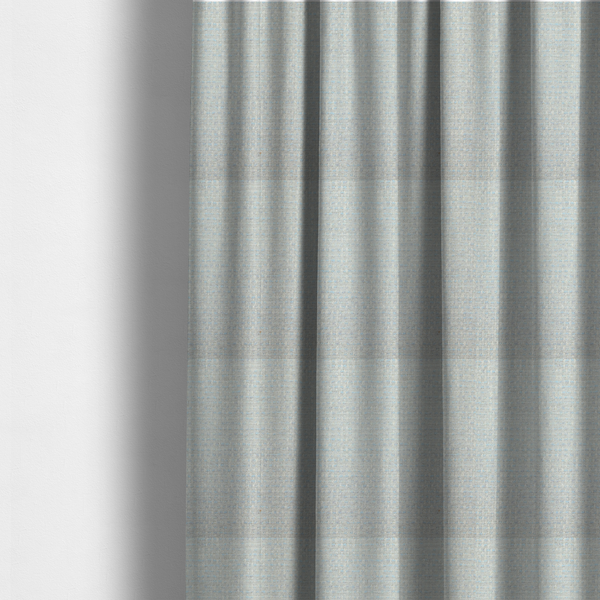 The fabric used to create these made-to-measure curtains is a material features a dense, light-toned weave with a pale cream and off-white base, subtly interlaced with delicate horizontal flecks of soft baby blue and light grey threads throughout.